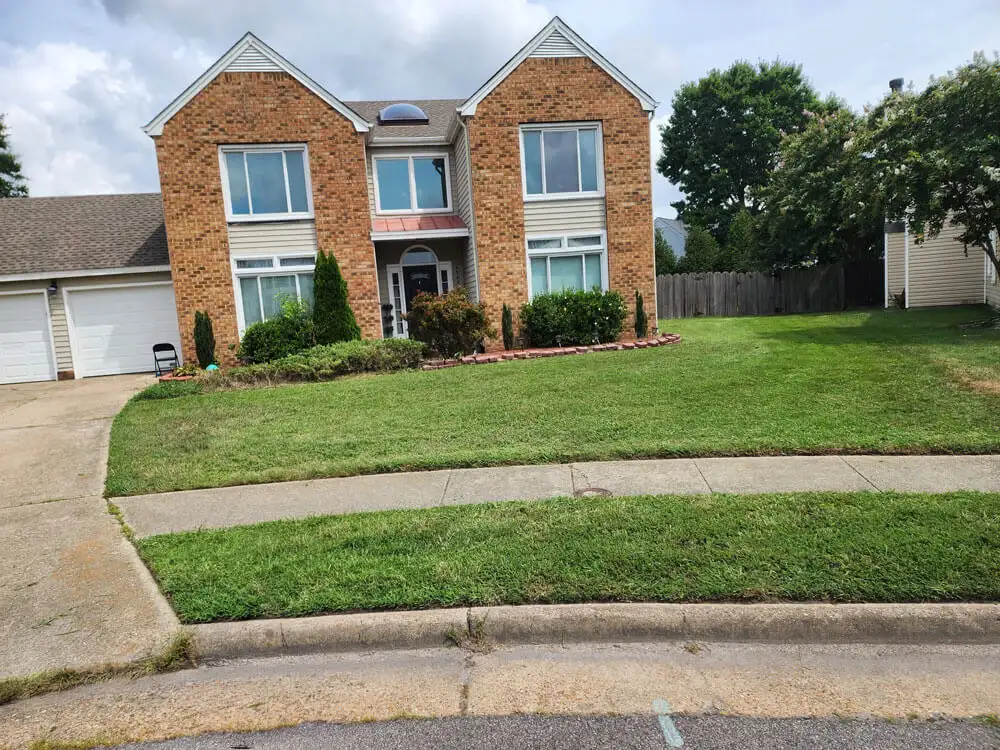 Freshly cut front lawn with clean mowing lines